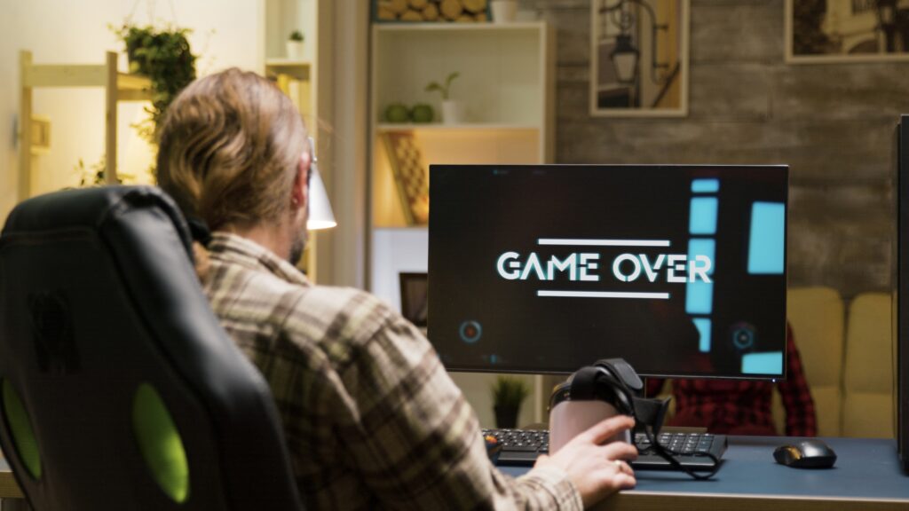 Adult man upset after losing while playing video games