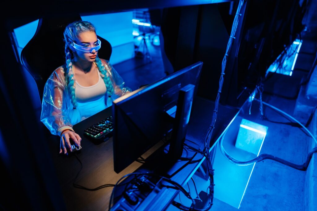 Young female cyber gamer, cosplayer plays computer games.